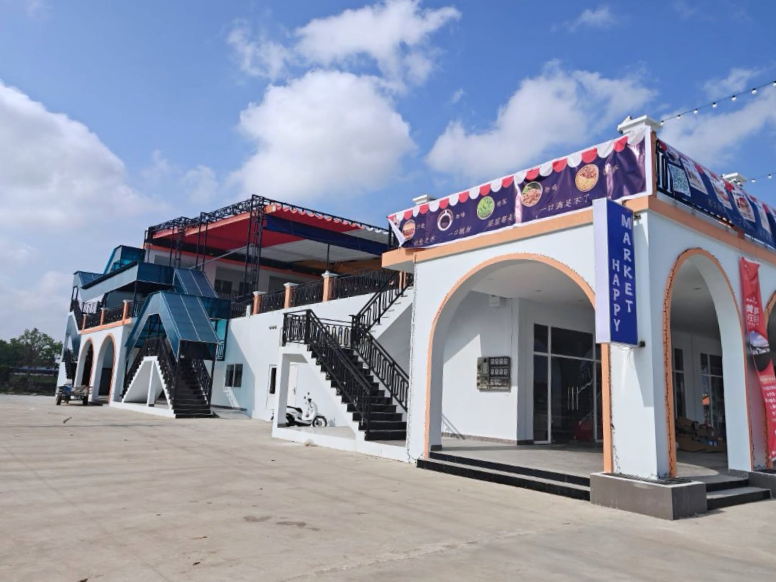 MSEZ commercial arcade with HAPPY MARKET and dining banners