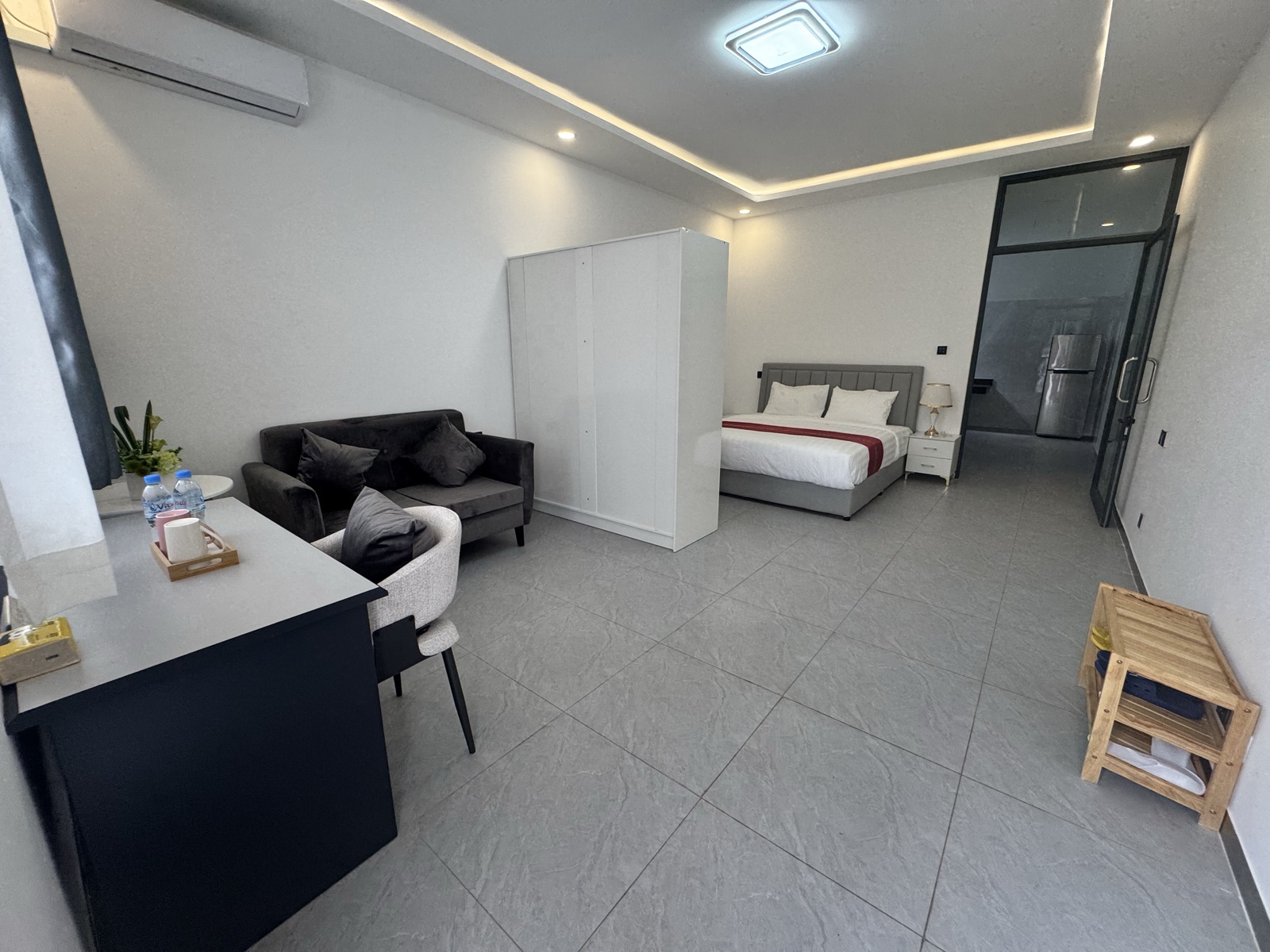 Single room panorama: sofa, desk and fridge